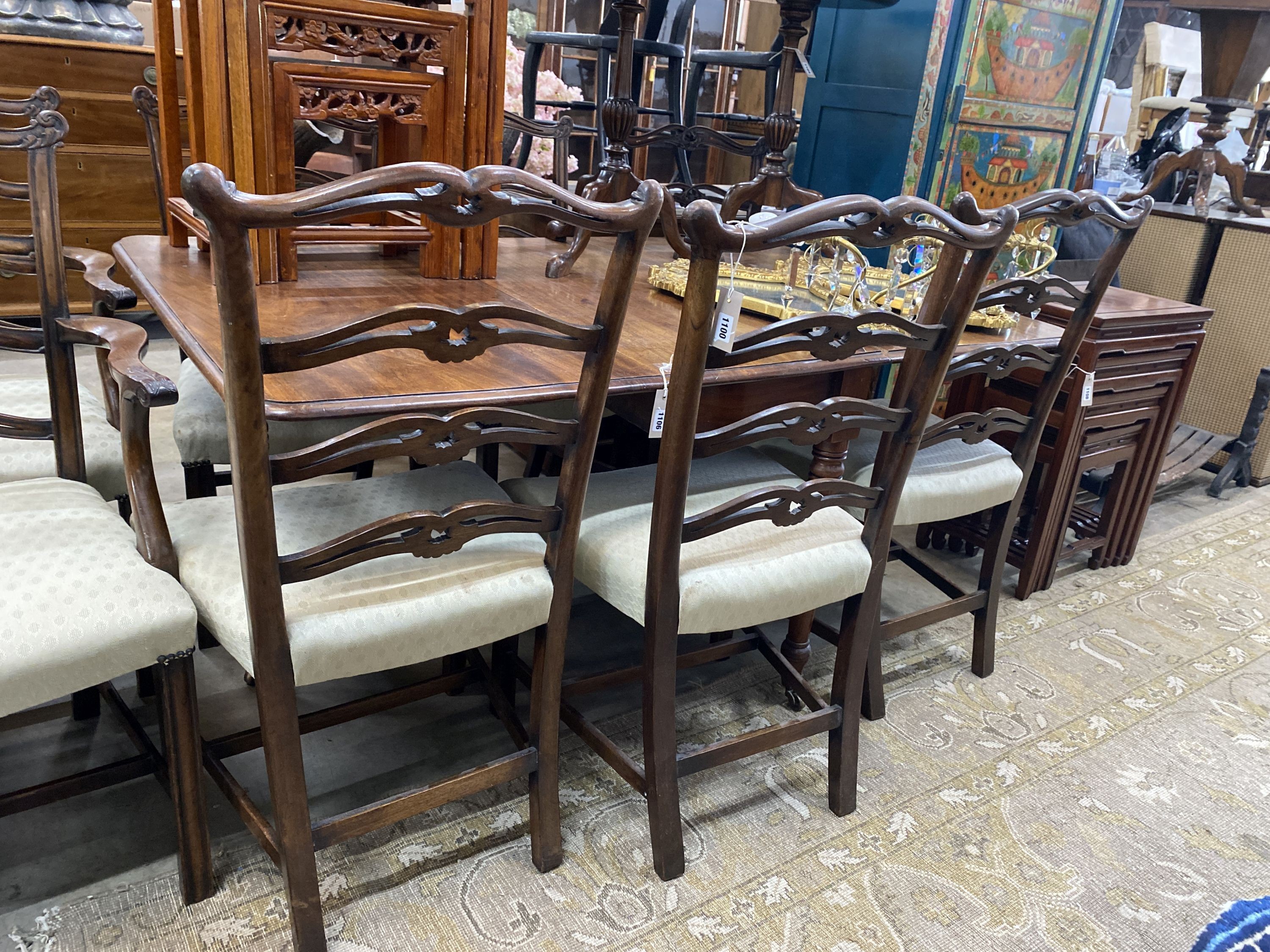 A set of eight Chippendale style mahogany dining chairs with pierced ladder backs, two with arms